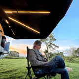 raxar awning with lights and person sitting under it